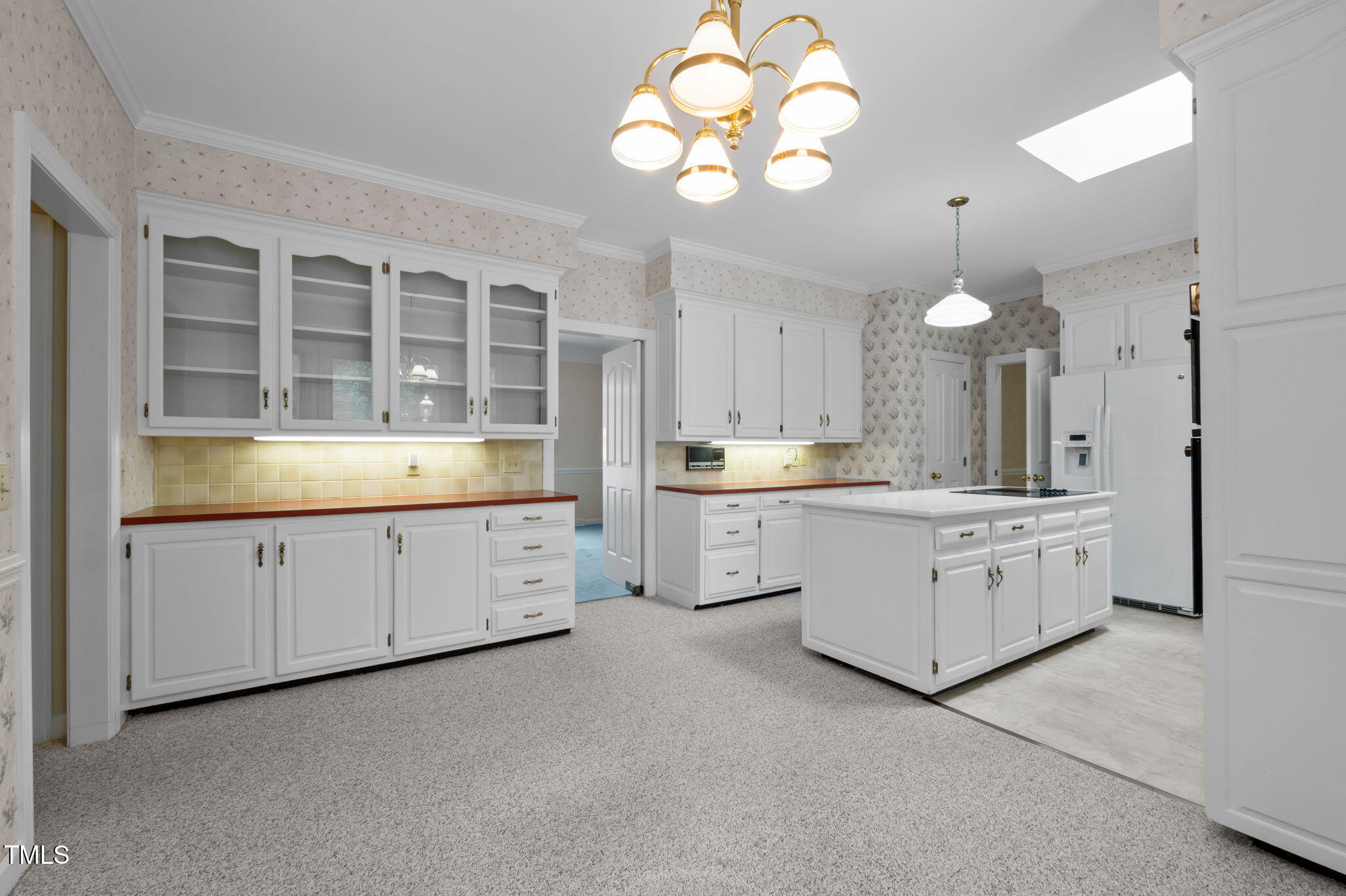 74 Alleghany Drive Roxboro, NC 27573 - Photo 17 of 62 a large white kitchen with a white cabinet a sink and dishwasher with white cabinets