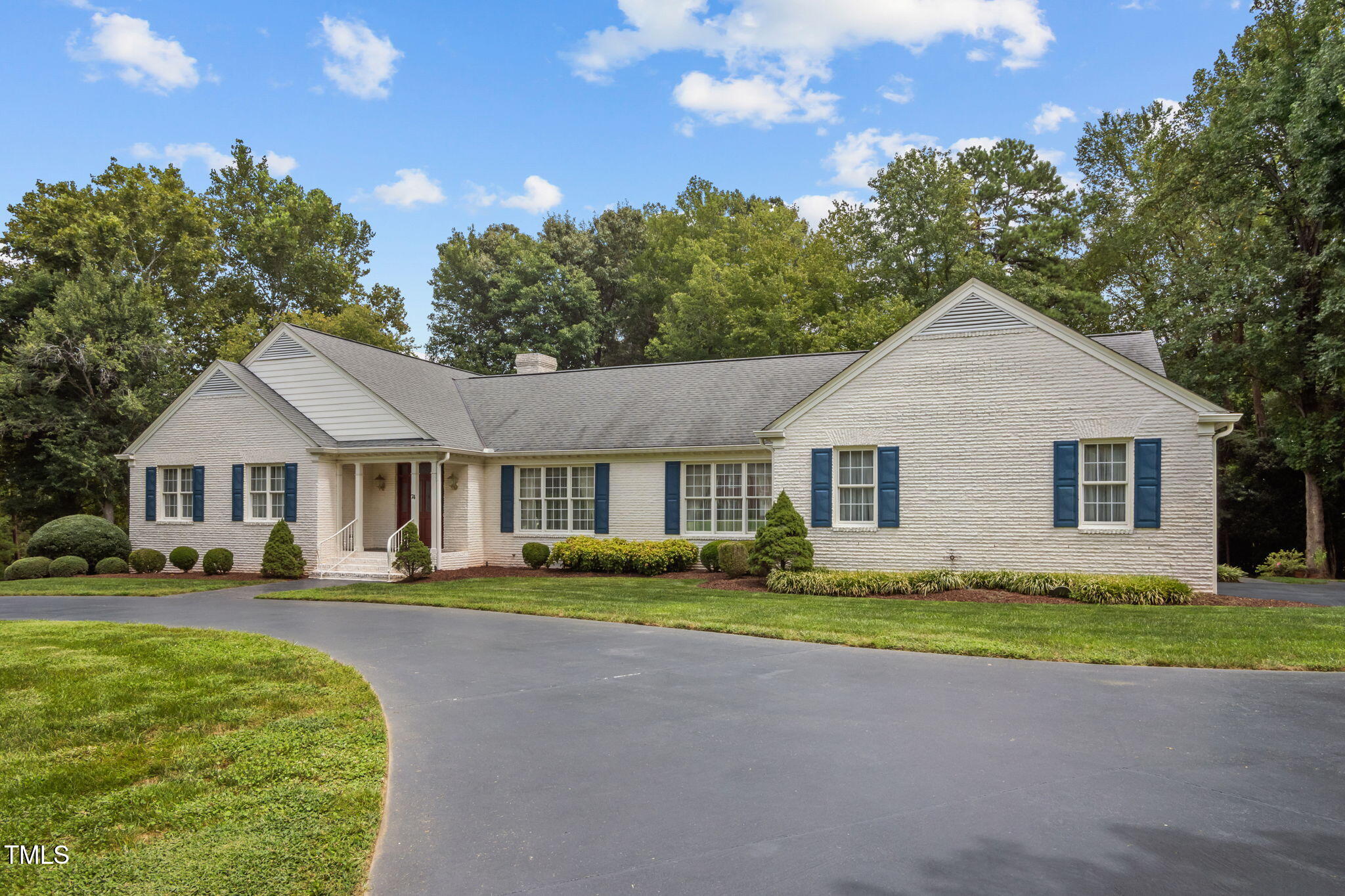 74 Alleghany Drive Roxboro, NC 27573 - Photo 2 of 62 a front view of a house with a garden and trees