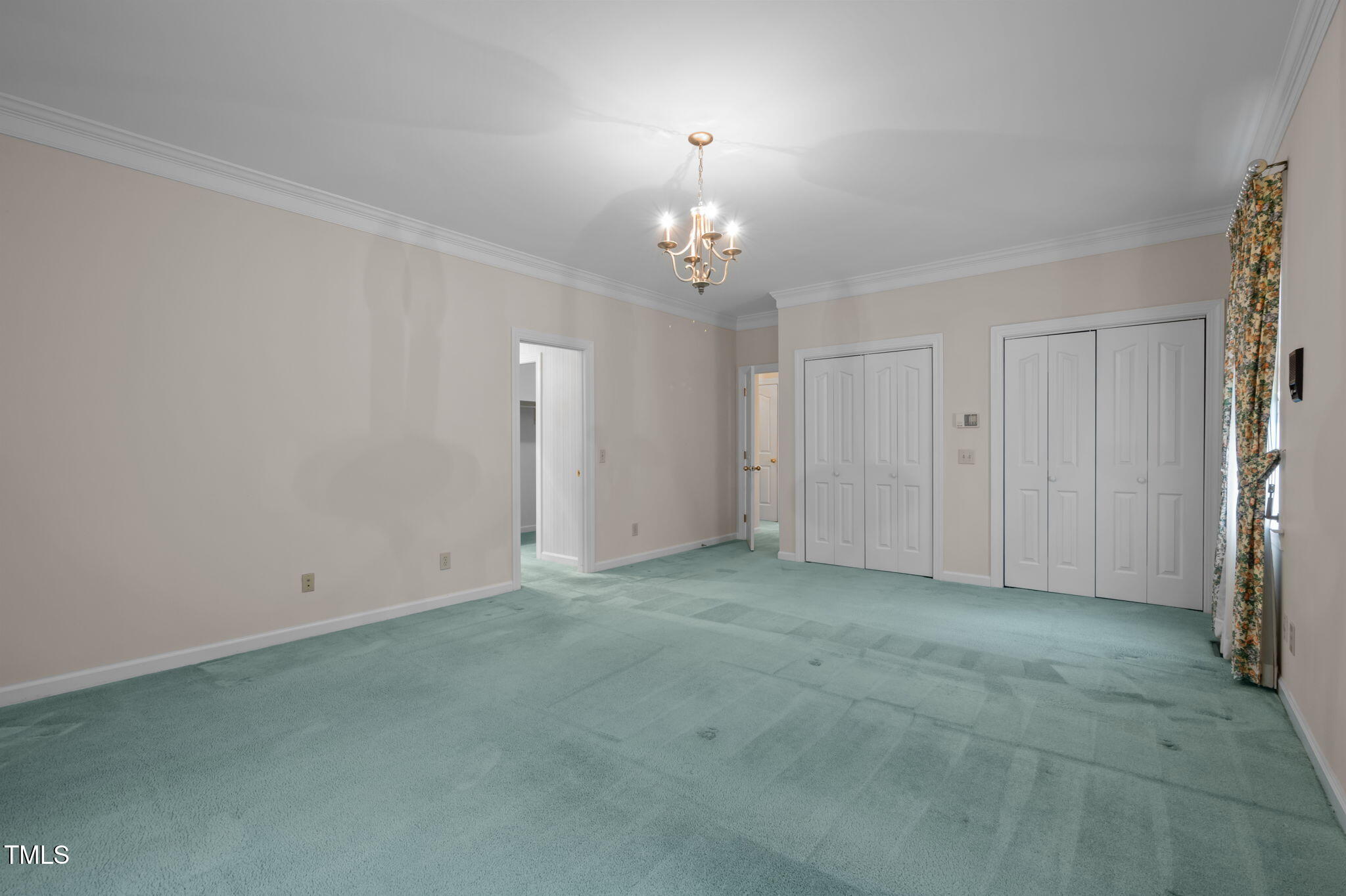 74 Alleghany Drive Roxboro, NC 27573 - Photo 23 of 62 an empty room with chandelier fan and windows