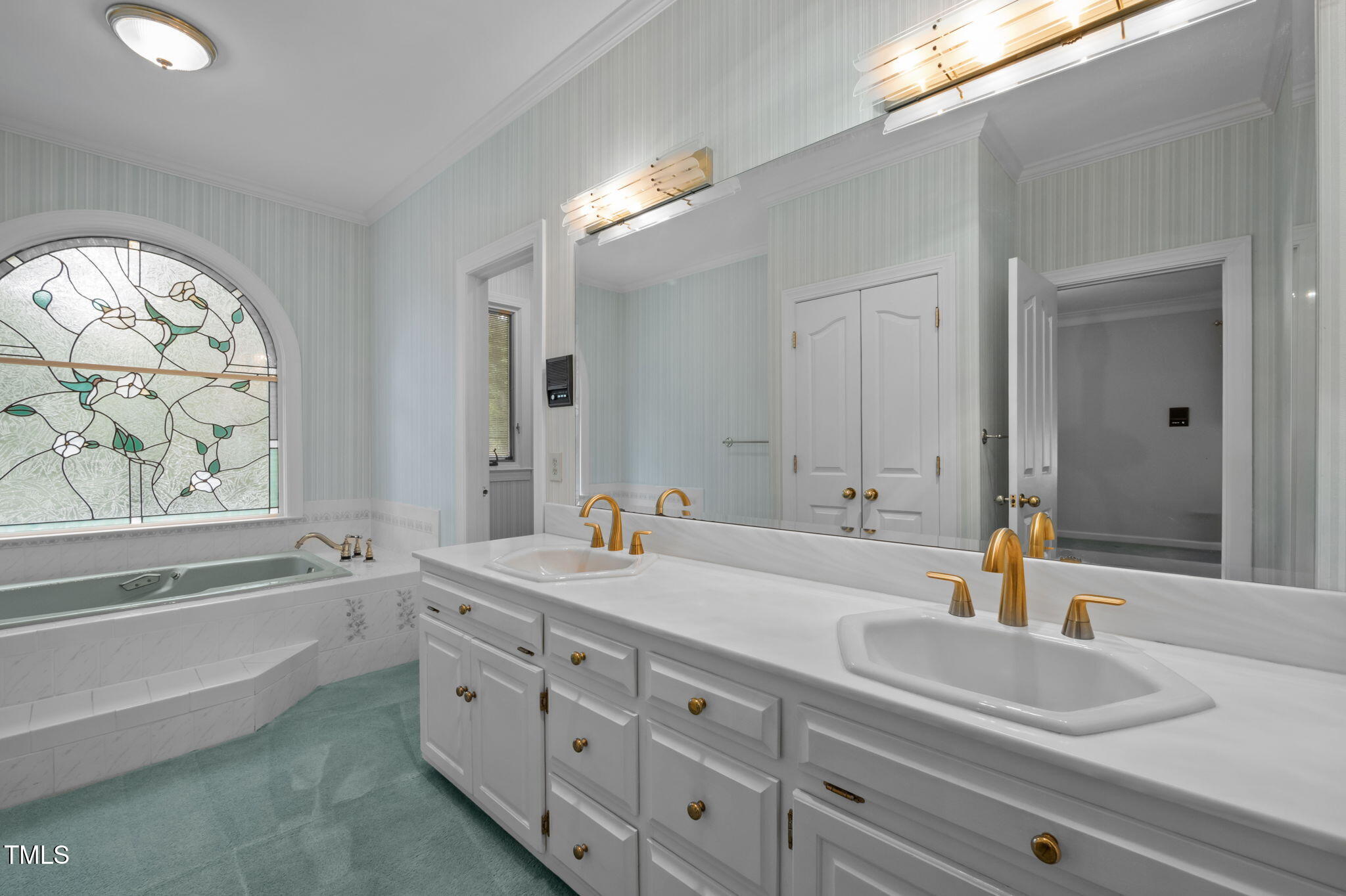 74 Alleghany Drive Roxboro, NC 27573 - Photo 24 of 62 a bathroom with double vanity sinks a large mirror and a bathtub