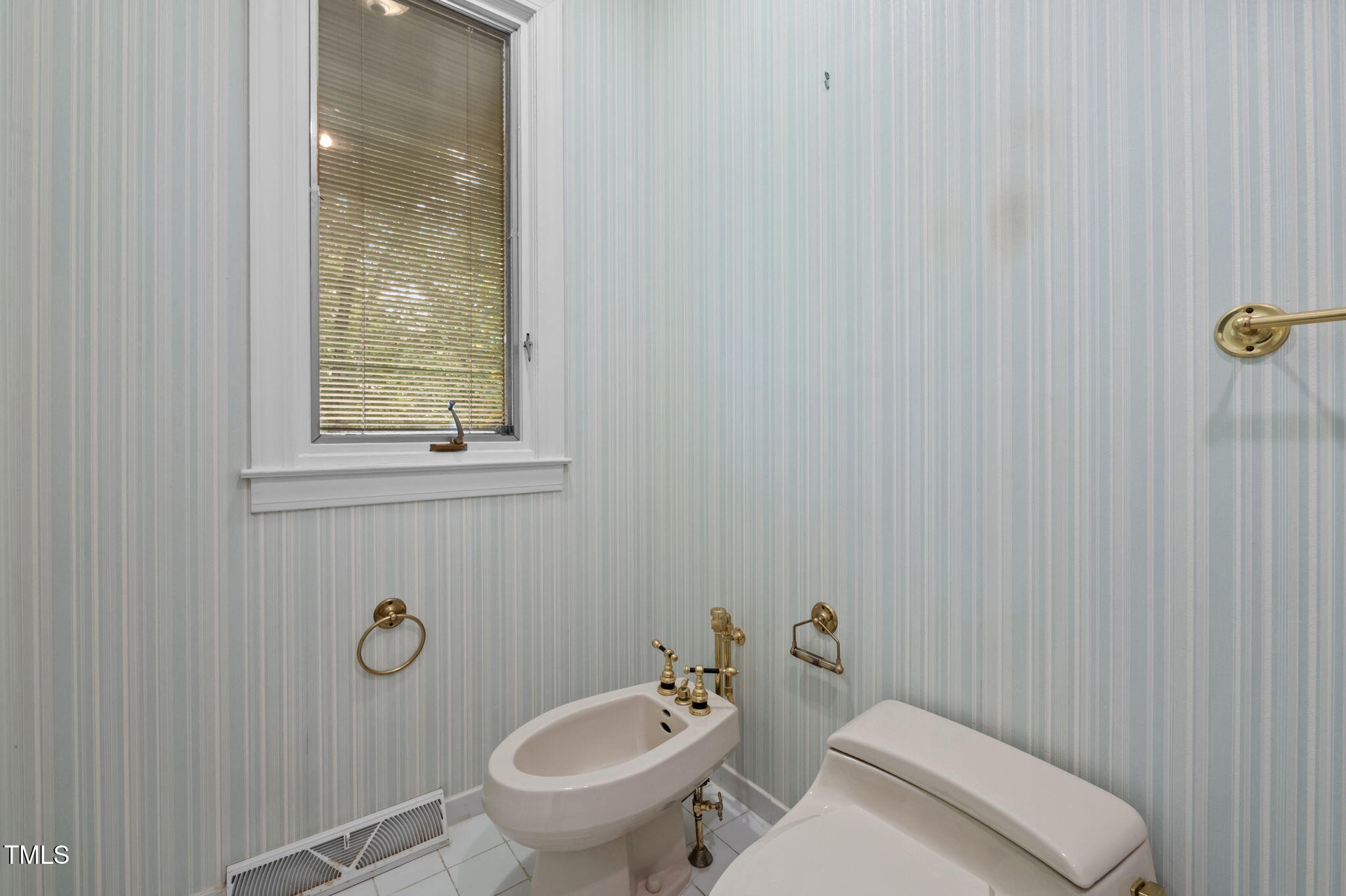 74 Alleghany Drive Roxboro, NC 27573 - Photo 26 of 62 a bathroom with a toilet a sink and mirror
