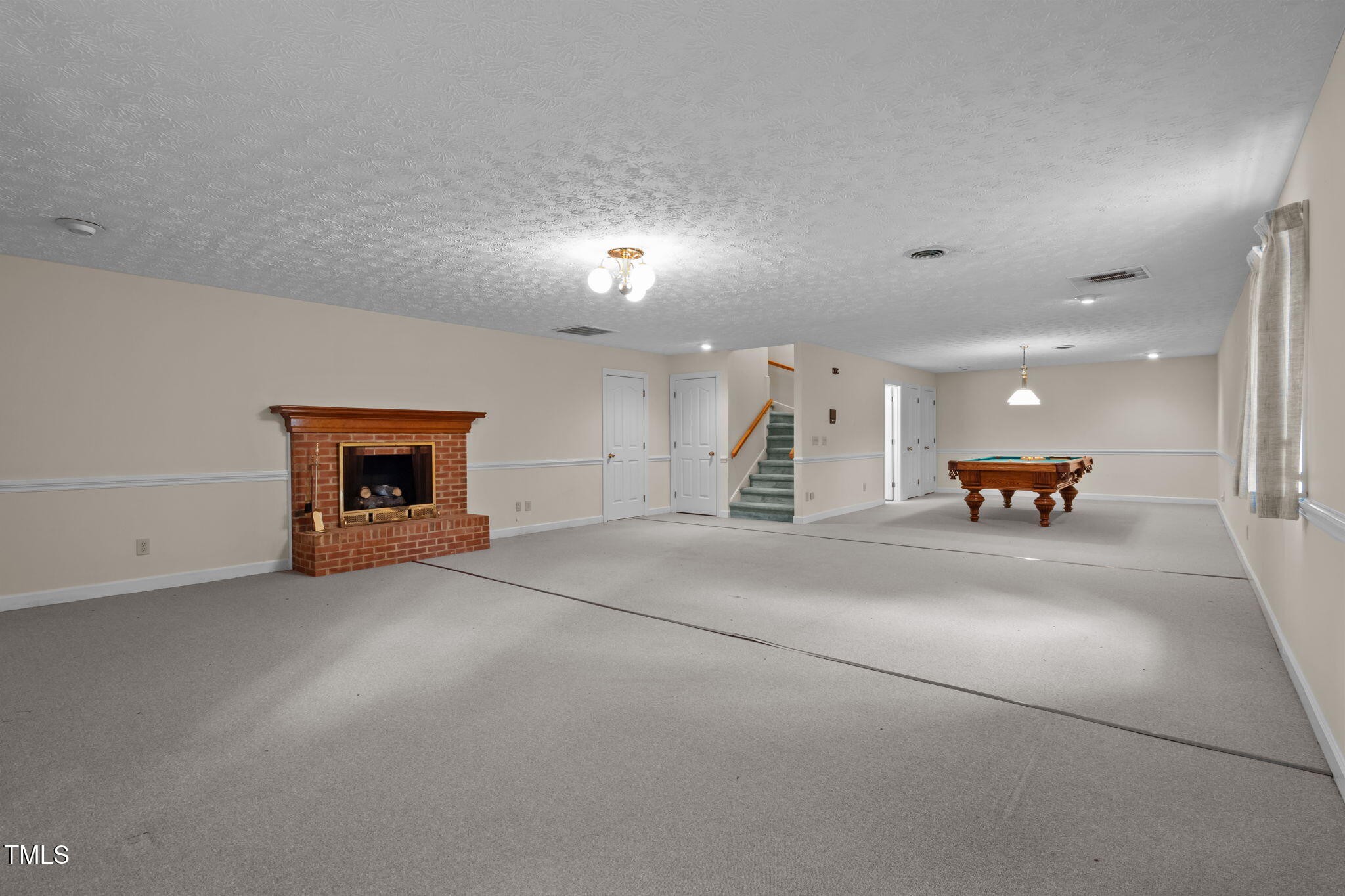 74 Alleghany Drive Roxboro, NC 27573 - Photo 37 of 62 an empty room with furniture and a fireplace