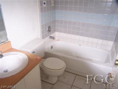 7529 Pebble Beach Road Fort Myers, FL 33967 - Photo 8 of 10 a white toilet sitting next to a bath tub