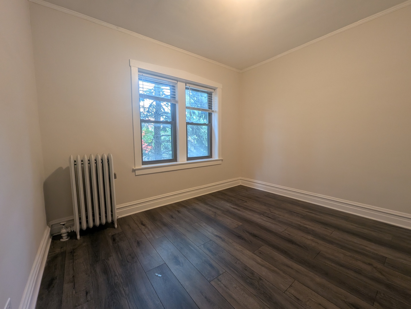 5820 West Berteau Avenue, Unit 2 Chicago, IL 60634 - Photo 6 of 12 an empty room with wooden floor and windows
