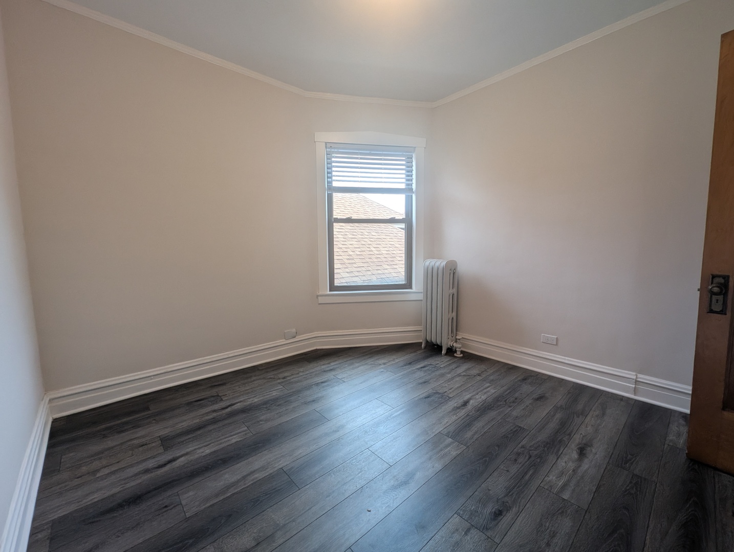 5820 West Berteau Avenue, Unit 2 Chicago, IL 60634 - Photo 8 of 12 an empty room with wooden floor and window