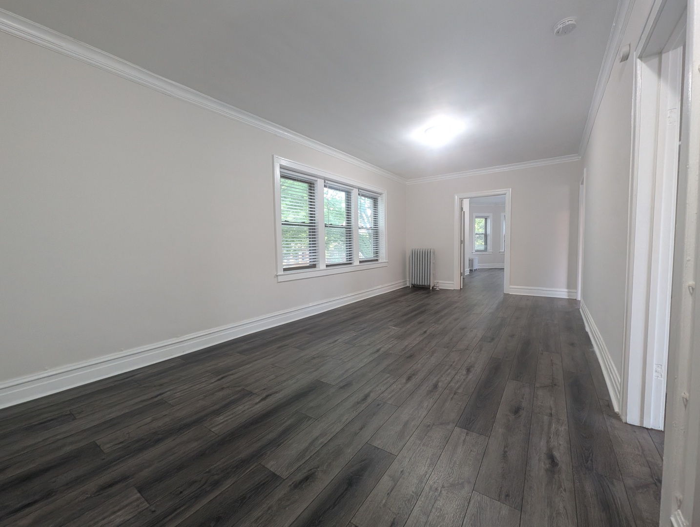 5820 West Berteau Avenue, Unit 2 Chicago, IL 60634 - Photo 9 of 12 an empty room with wooden floor and windows
