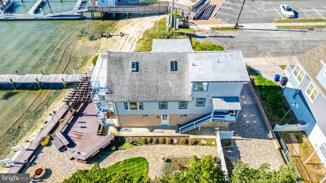 a living room with a large window and a chandelier