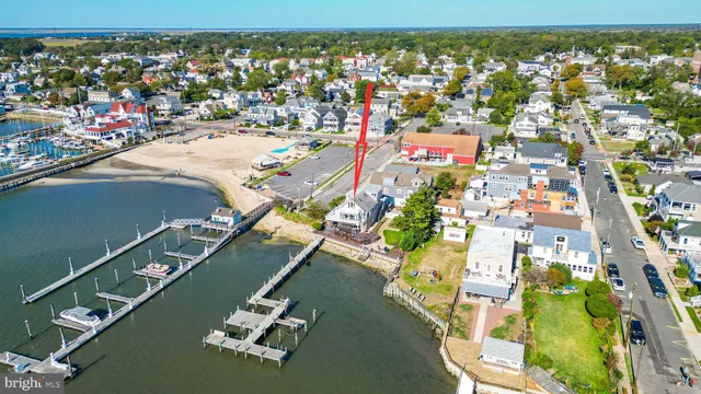 a aerial view of a house with swimming pool lawn chairs and a fire pit