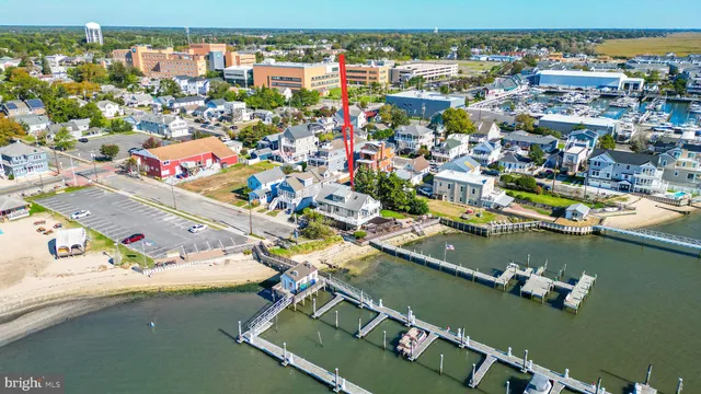 an aerial view of a house with a garden and lake view