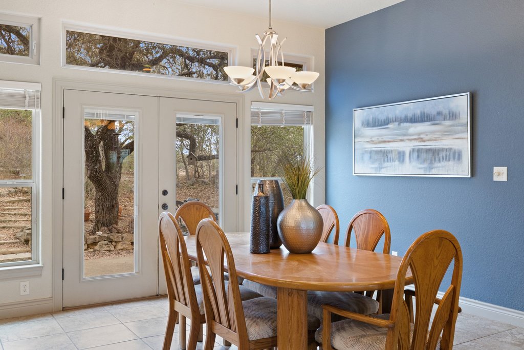 232 Crooked Oak Round Mountain, TX 78663 - Photo 12 of 40 Dining room with a chandelier, french doors, and light tile patterned floors