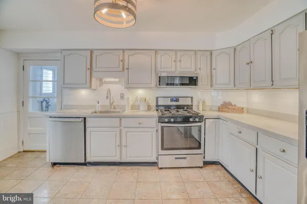 a kitchen with stainless steel appliances granite countertop a sink and cabinets