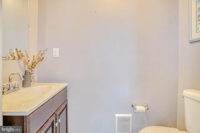 a bathroom with a sink a toilet and mirror