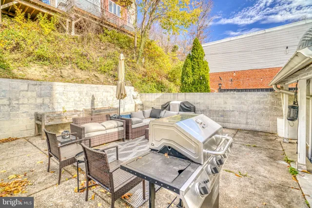 a view of a patio with table and chairs and potted plants