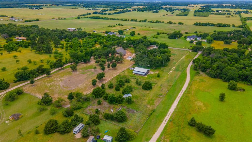 Tbd Wiggins Road West, TX 76691 - Photo 10 of 11 Expansive acreage featuring abundant mature trees, open clearings, a gravel driveway, and a barn structure