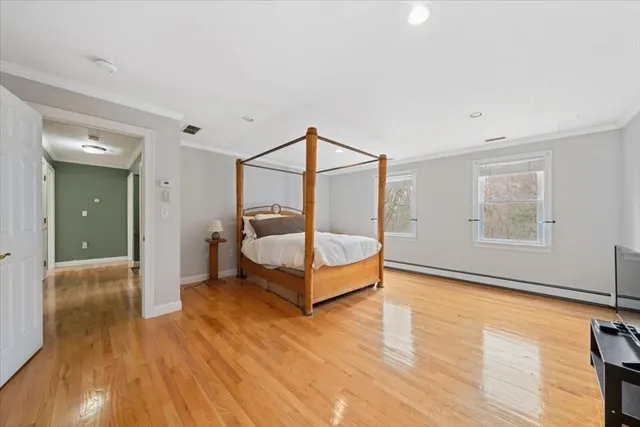 a living room with wooden floor and furniture