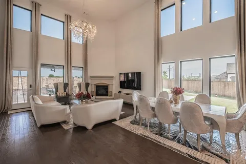 a living room with fireplace furniture and a large window