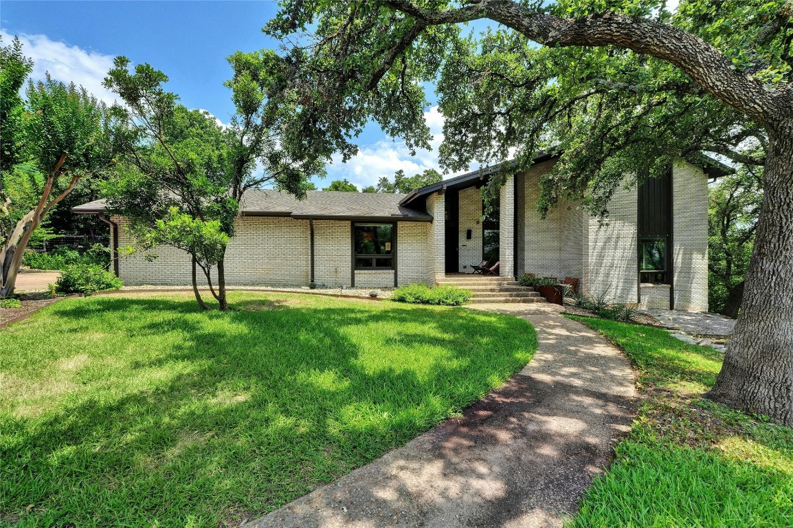a front view of house with yard and green space
