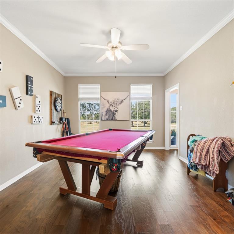 785 Tweedy Road Valley Mills, TX 76689 - Photo 17 of 40 Spacious room featuring wood-finish flooring, crown molding, and a ceiling fan