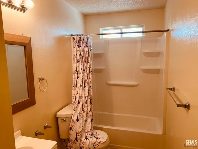 a bathroom with a shower and a toilet