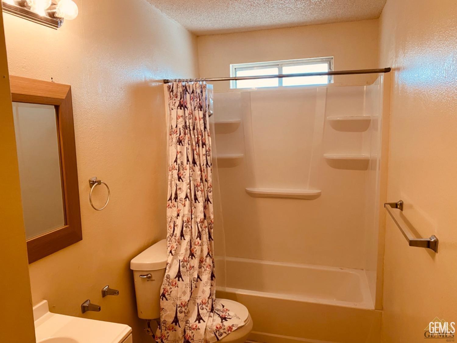 Undisclosed Address Delano, CA 93215 - Photo 4 of 7 a bathroom with a shower and a toilet