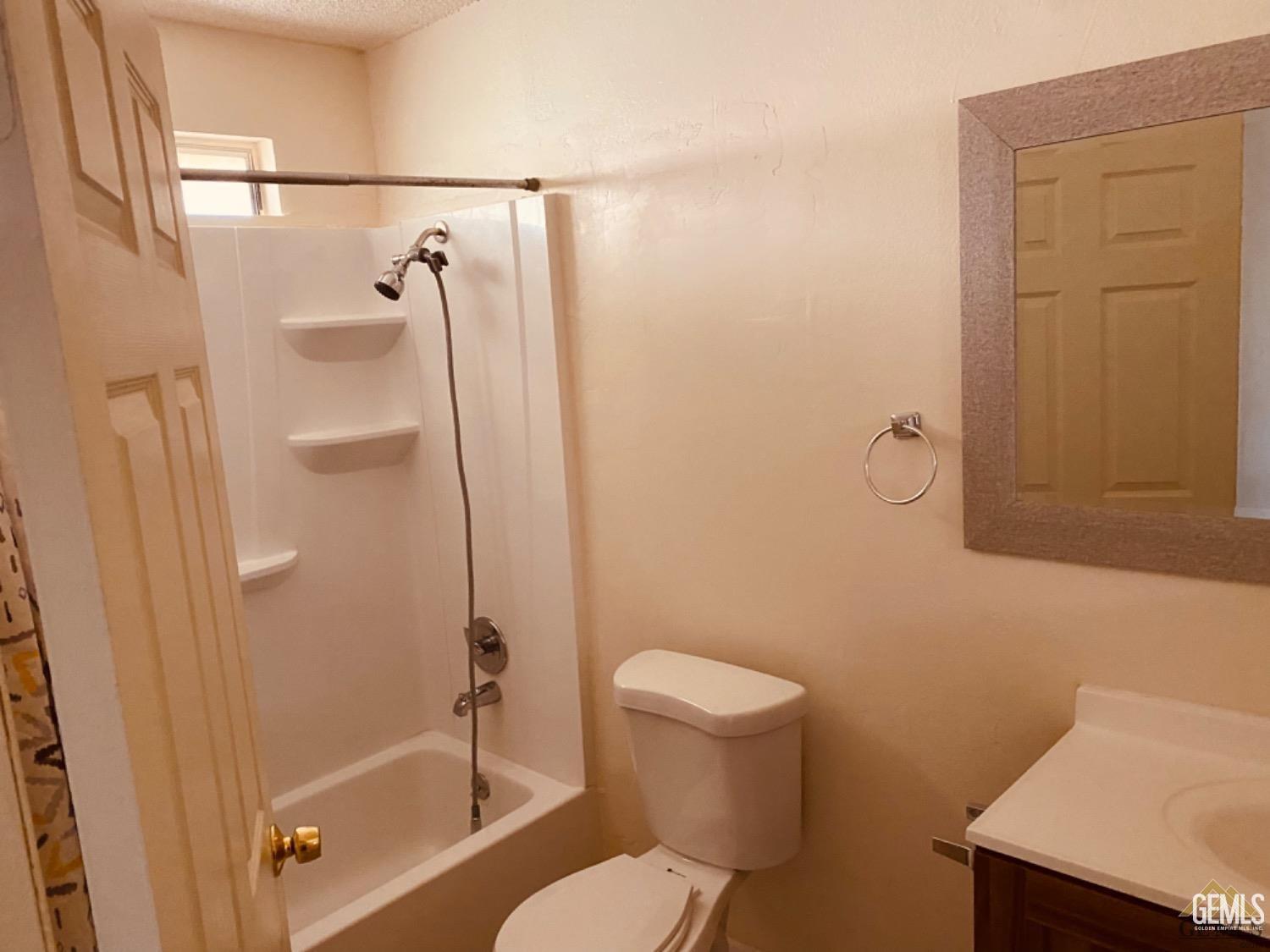 Undisclosed Address Delano, CA 93215 - Photo 5 of 7 a bathroom with a shower a toilet and a sink