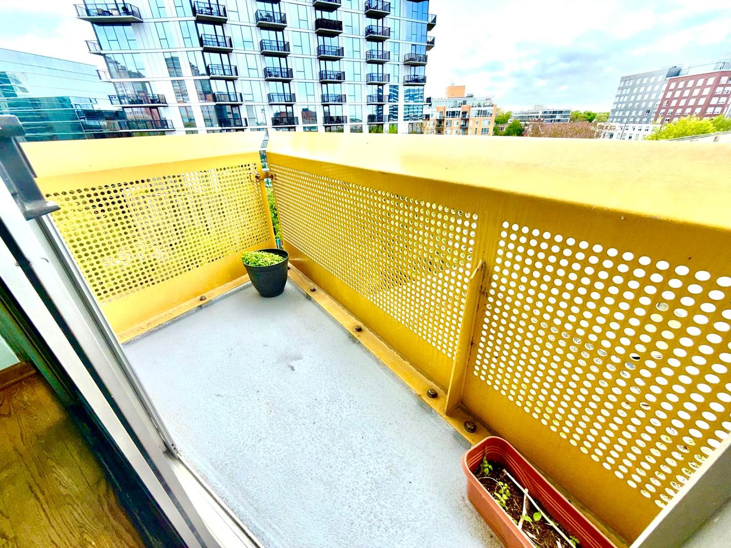 1720 Maple Avenue, Unit 780 Evanston, IL 60201 - Photo 17 of 57 a view of a balcony with wooden floor