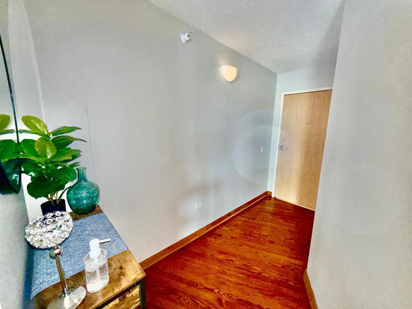 1720 Maple Avenue, Unit 780 Evanston, IL 60201 - Photo 2 of 57 a view of a room with table and a potted plant