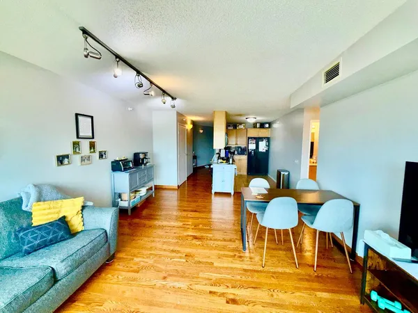 a living room with furniture and a wooden floor