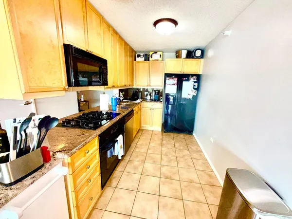 a kitchen with a sink appliances cabinets and a counter top space