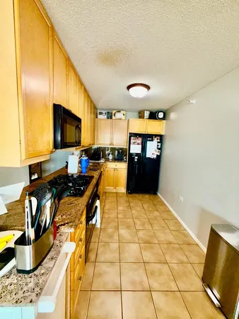 a kitchen with stainless steel appliances kitchen island granite countertop a sink and cabinets