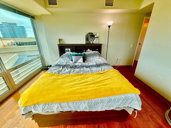 a bed sitting in a bedroom next to a window