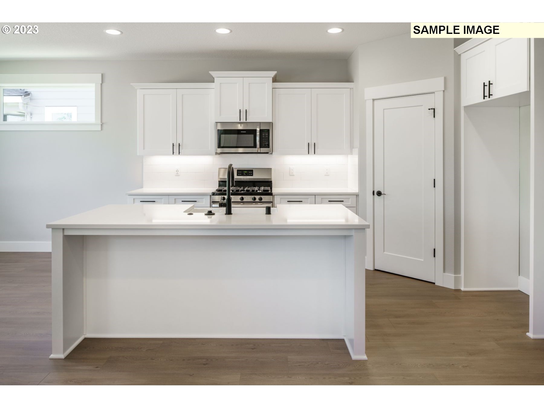 715 Northwest 178th Street Ridgefield, WA 98642 - Photo 5 of 23 a kitchen with kitchen island cabinets and refrigerator