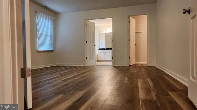 a view of a room with wooden floor and window