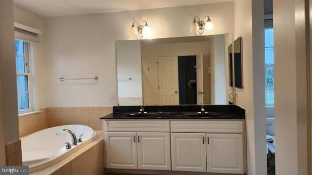 a bathroom with a bathtub and shower