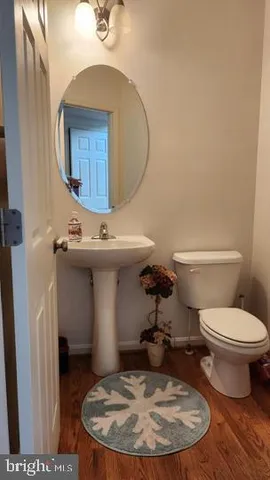 a bathroom with a toilet a sink and a mirror