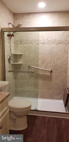 a bathroom with a toilet and a shower