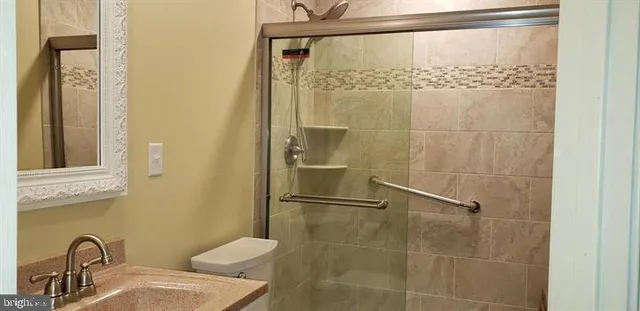 a bathroom with a shower and a sink