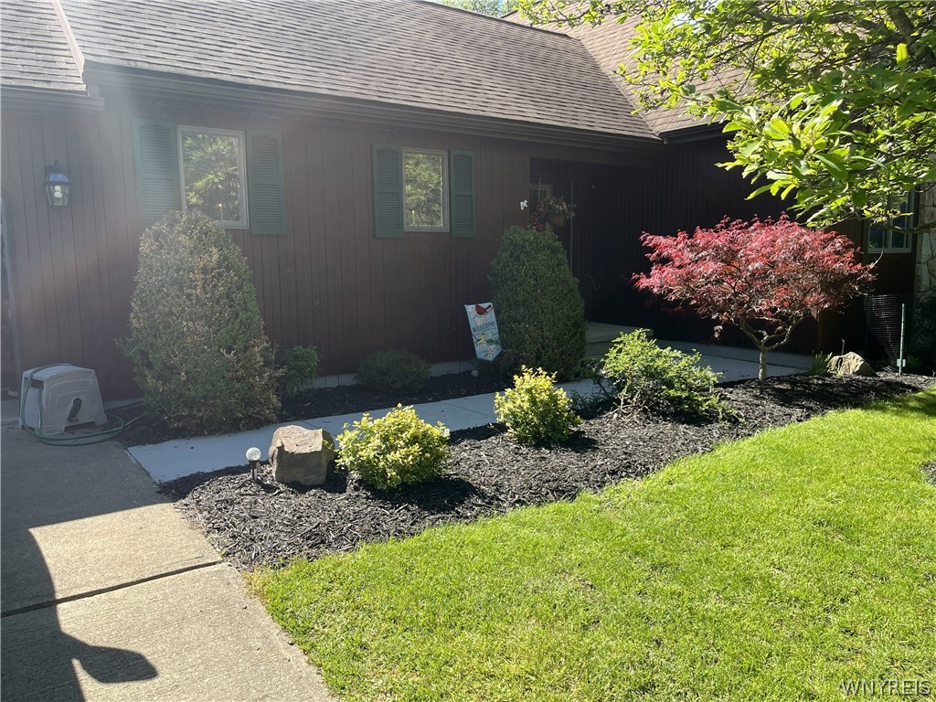 Mature landscaping frames the entryway and classic