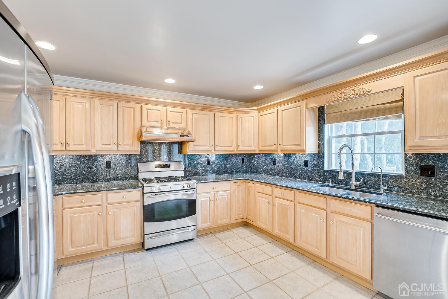 29 Hillsdale Road Edison, NJ 08820 - Photo 14 of 55 a kitchen with stainless steel appliances granite countertop a stove a sink and a microwave