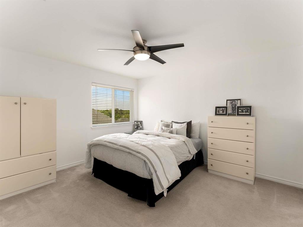 7436 Stoney Point Drive Plano, TX 75025 - Photo 15 of 40 a bedroom with a bed and a window