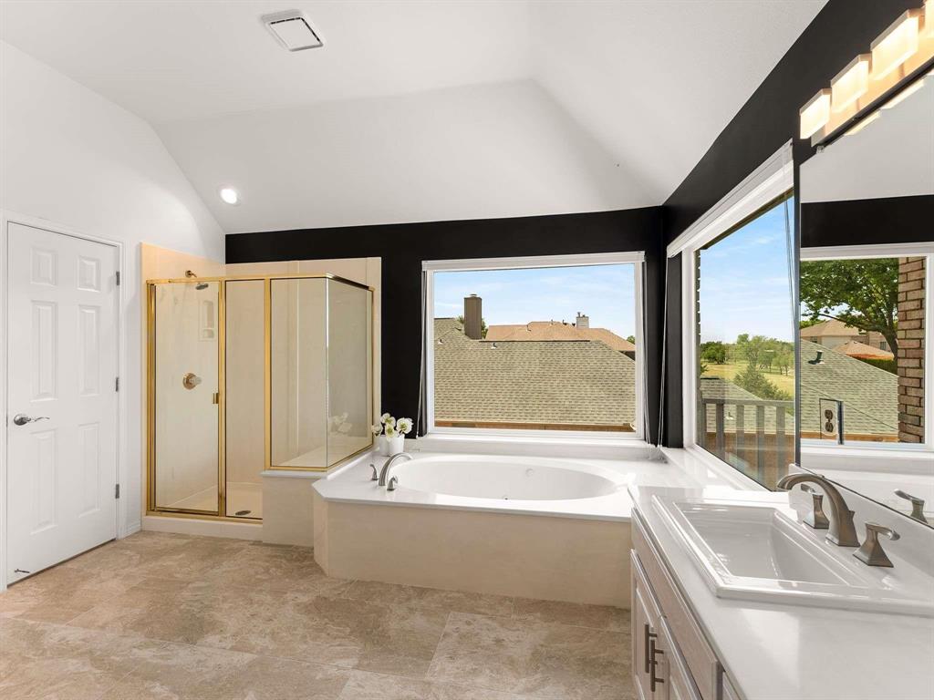 7436 Stoney Point Drive Plano, TX 75025 - Photo 16 of 40 a bathroom with a large tub a sink and large window