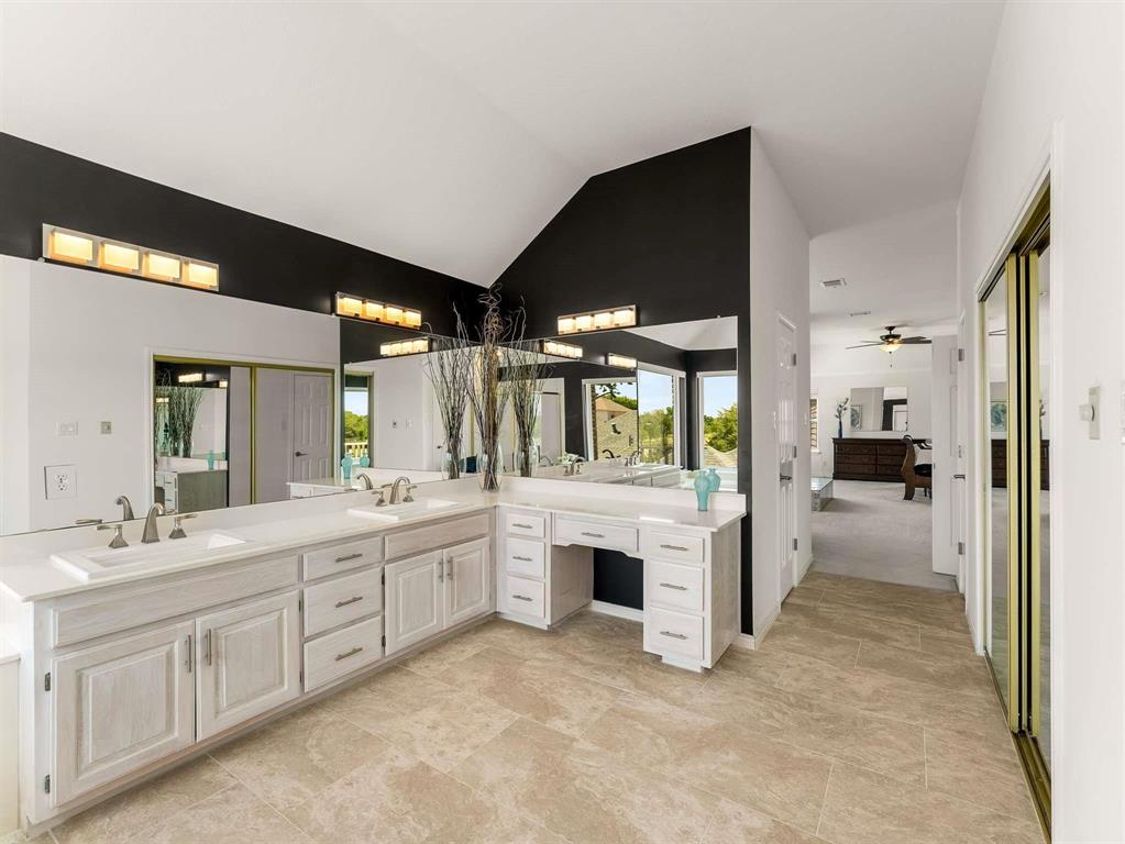 7436 Stoney Point Drive Plano, TX 75025 - Photo 18 of 40 a bathroom with a sink and mirror