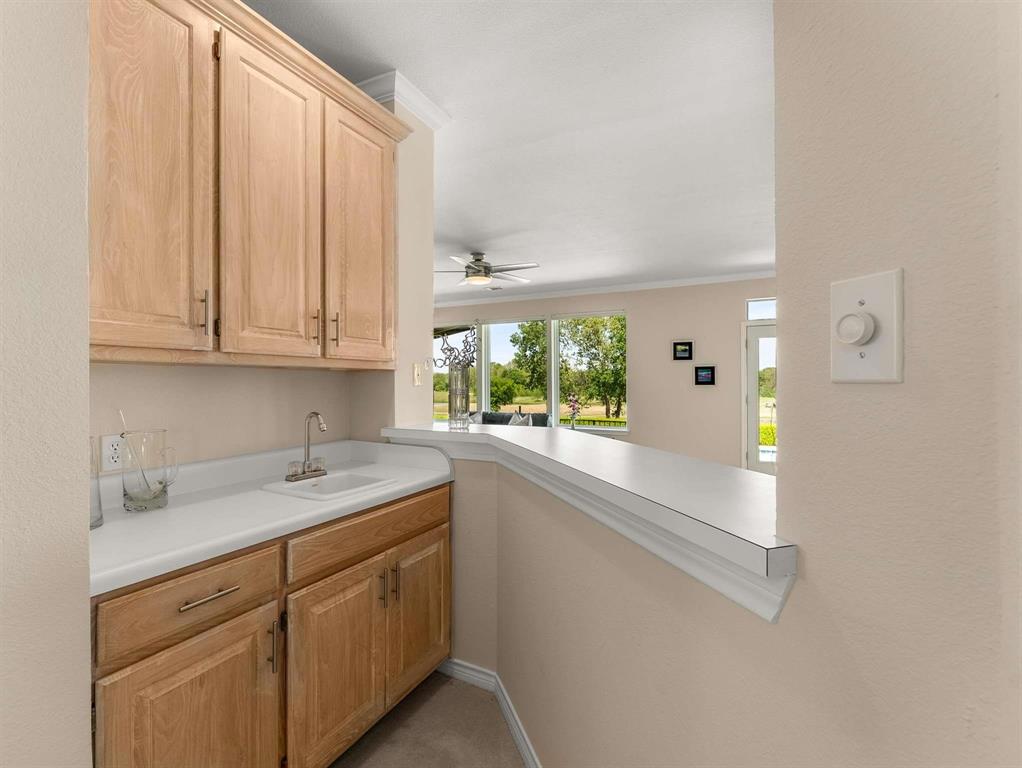 7436 Stoney Point Drive Plano, TX 75025 - Photo 25 of 40 a kitchen with a sink and cabinets