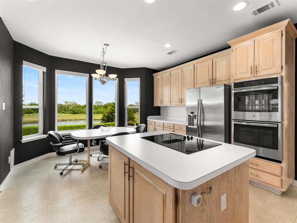 7436 Stoney Point Drive Plano, TX 75025 - Photo 31 of 40 a kitchen with a stove a sink and a refrigerator