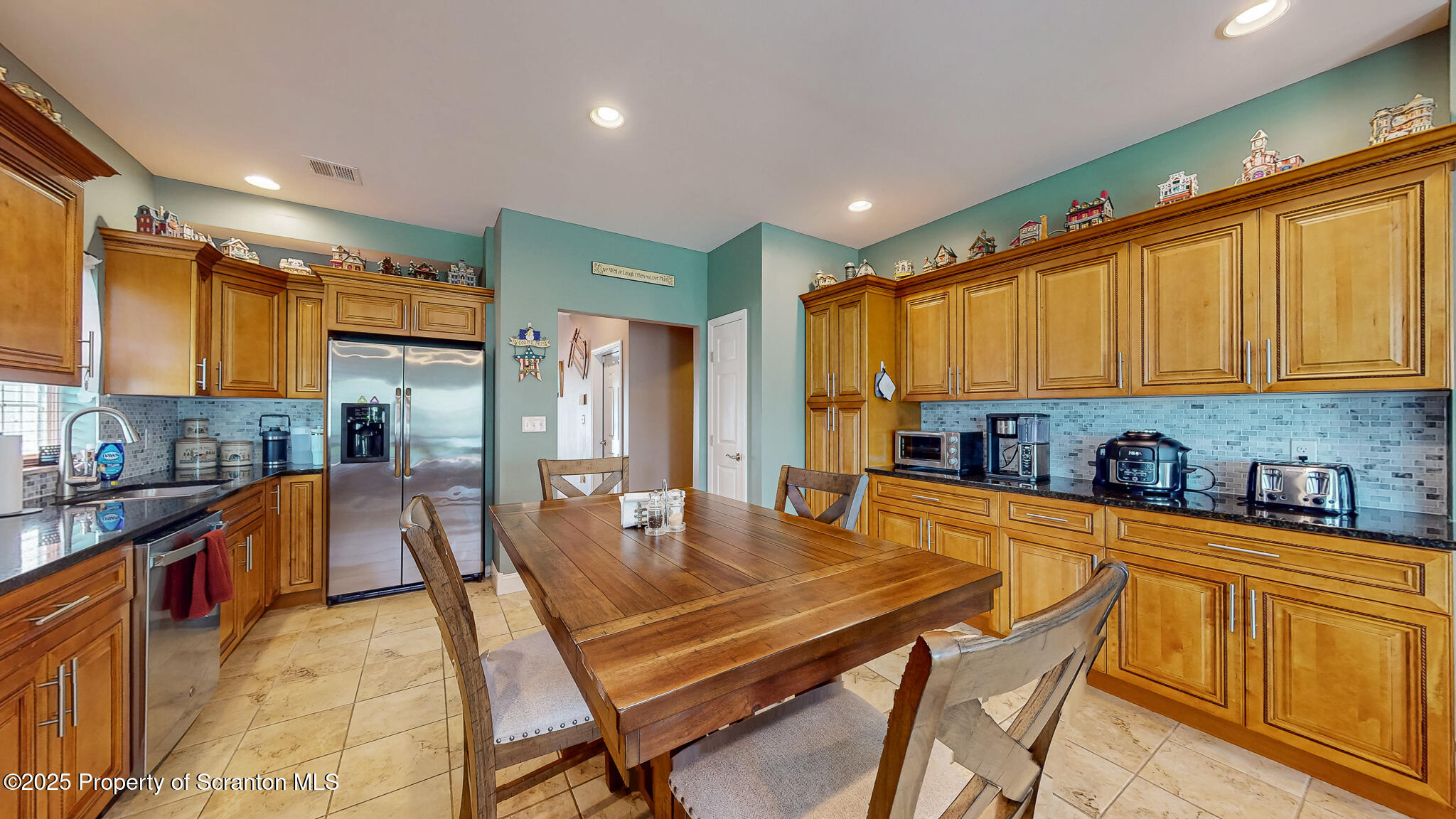 233 Shadow Wood Circle Archbald, PA 18403 - Photo 11 of 62 a dining room with stainless steel appliances a dining table chairs and large window