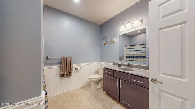 a kitchen with stainless steel appliances kitchen island granite countertop a refrigerator and a stove top oven