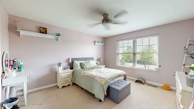 a bedroom with a bed dresser and a window