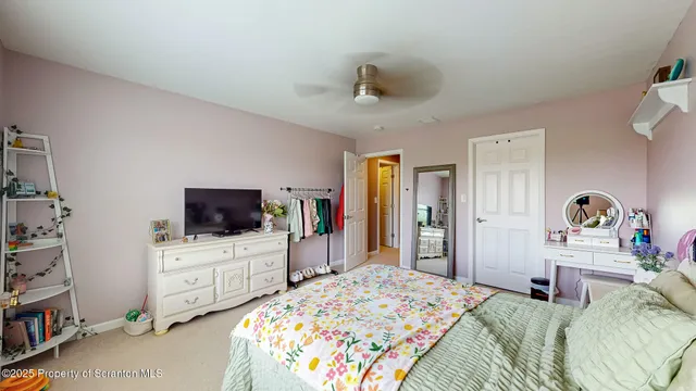 a bathroom with a granite countertop sink a toilet and a mirror