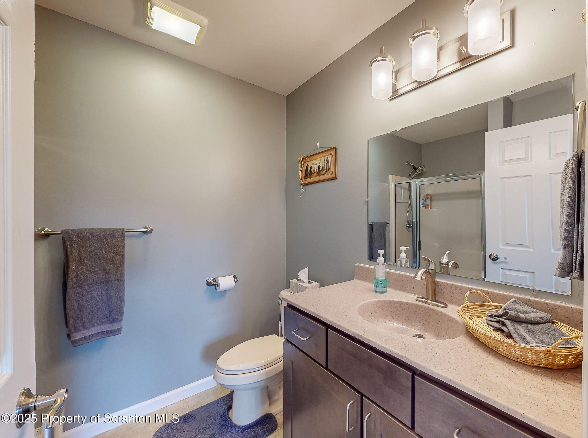 233 Shadow Wood Circle Archbald, PA 18403 - Photo 39 of 62 a bathroom with a granite countertop sink a toilet and a mirror