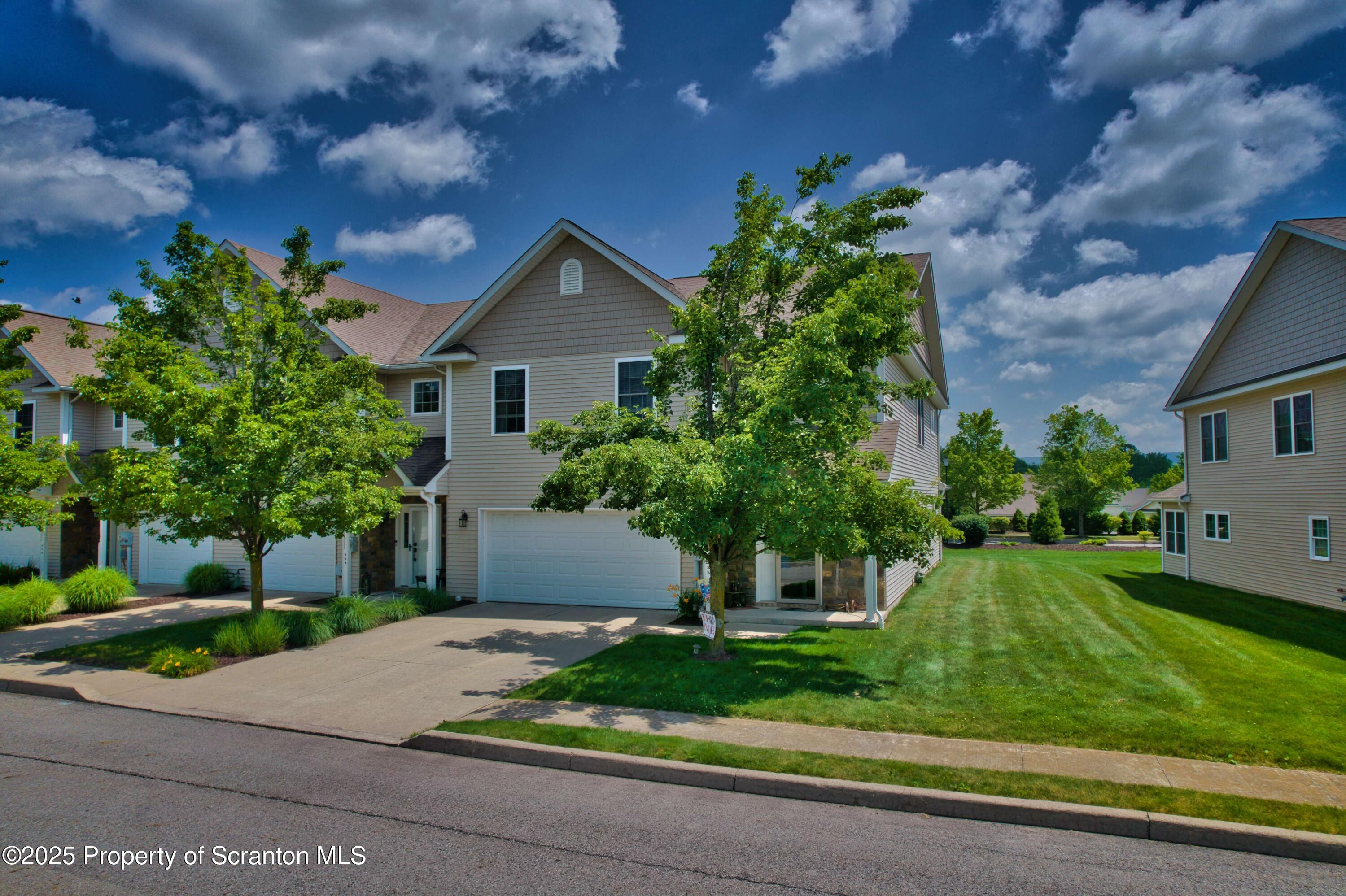 233 Shadow Wood Circle Archbald, PA 18403 - Photo 46 of 62 a front view of a house with a yard and a garage